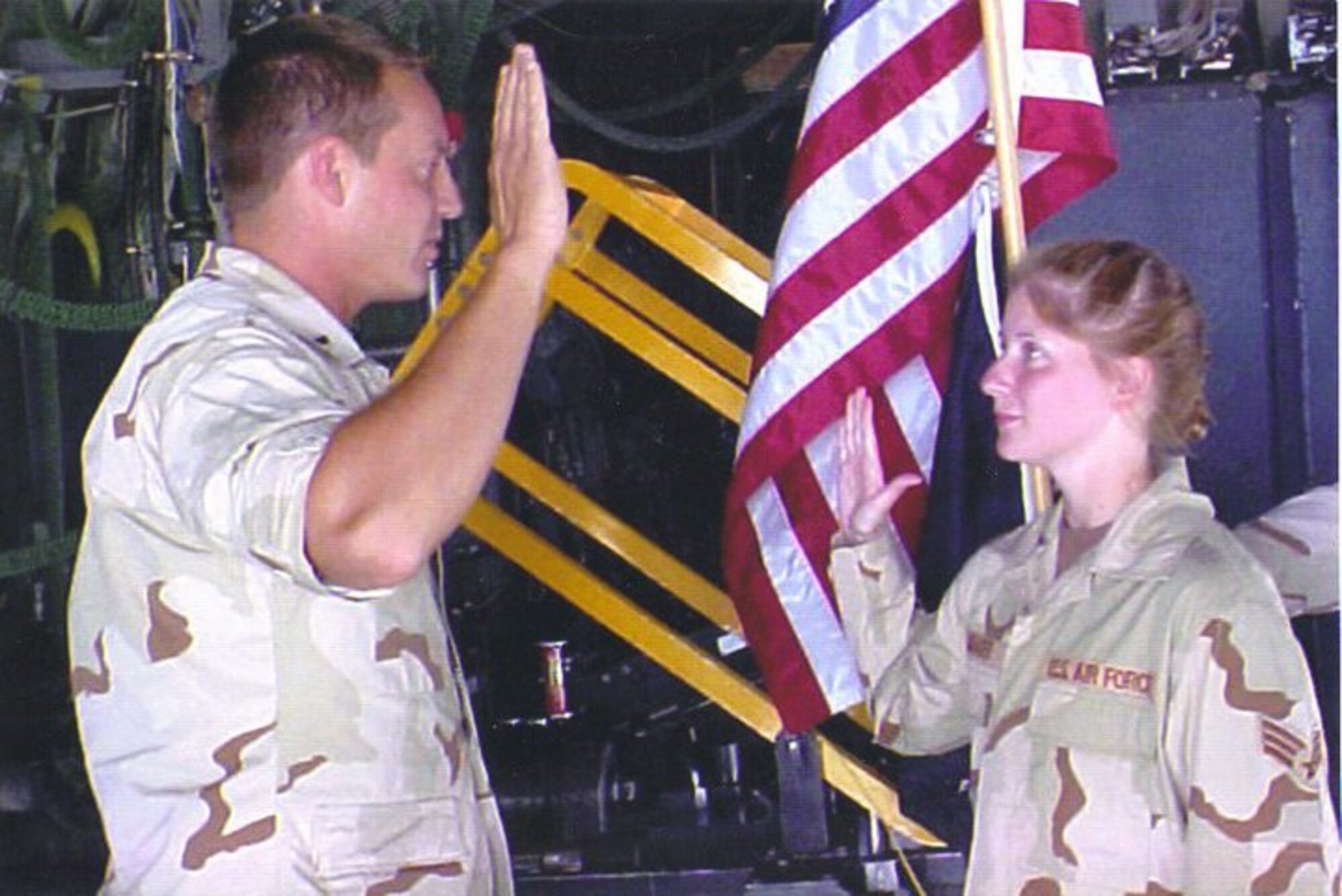 Then Senior Airman Summer Chamberlain is reenlisted by her flight commander, 1st Lt. Luke Barringer, while deployed to Southwest Asia Sept. 27, 2002. It was Chamberlain’s first reenlistment ceremony, and it took place aboard a C-130 gunship. (Courtesy photo)