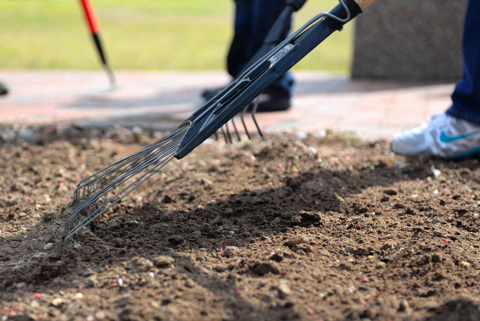 Children from the 20th Force Support Squadron Youth Center rake the earth to get it ready for planting at the 20th FSS Fitness Center April 22, 2014, at Shaw Air Force Base, S.C. The children were participating in a beautification project for Earth Day in the front entrance of the center. (U.S. Air Force photo by Airman 1st Class Diana M. Cossaboom/Released)