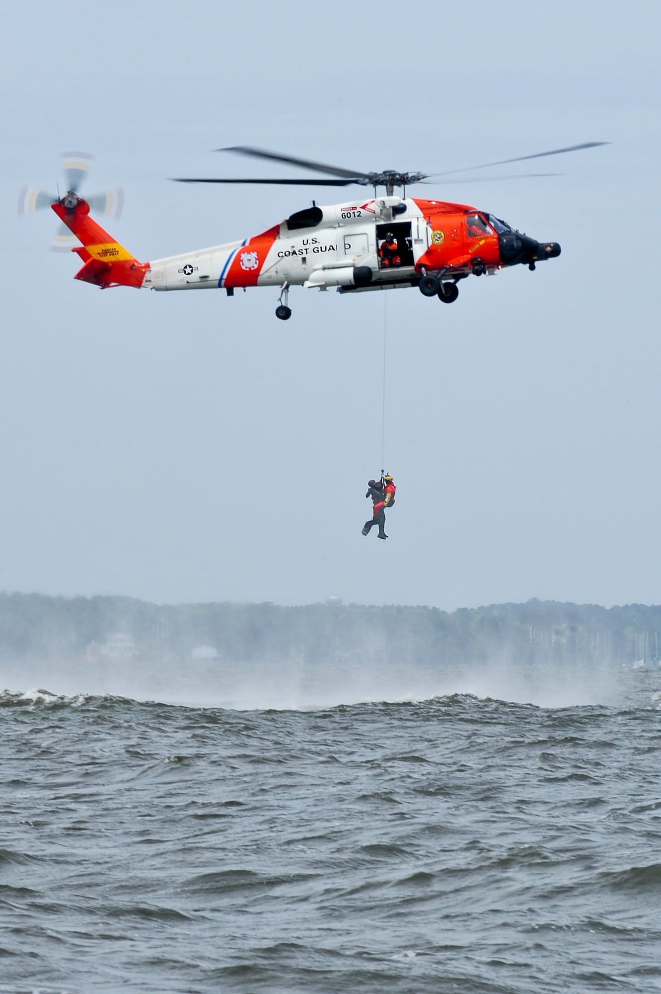 A U.S. Coast Guard rescue swimmer ascends into a helicopter after saving a downed pilot during a search and rescue training mission, April 18, 2014, in the Neuse River outside Oriental, N.C.  The mission was part of exercise RAZOR TALON exercise RAZOR TALON, a 4th Fighter Wing training initiative that provides a low-cost, large-force exercise training opportunity for joint East Coast tactical and support aviation units.  (U.S. Air Force photo/Airman 1st Class Brittain Crolley)