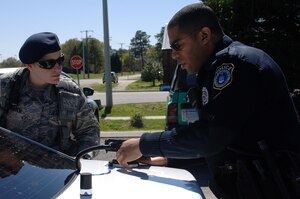 U.S. Air Force Senior Airman Sandra Chisholm, 633rd SFS response force leader, shadows Derrick Lee, 733rd SFS Traffic Accident Investigations police officer on the job at Fort Eustis, Va., April 16, 2014. Chisholm participated in the Security Forces/Military Police Exchange Program, where Service members from respective units switch places. (U.S. Air Force photo by Senior Airman Teresa J.C. Aber/Released)