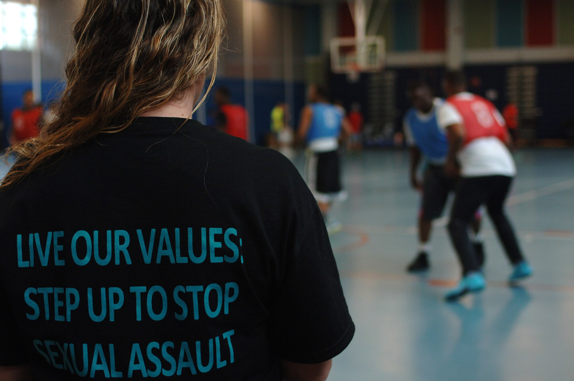 U.S. Army Sgt. 1st Class Angela Dees, 2nd Battalion, 210th Aviation Regiment, 128th Avn. Brigade training developer, watches the Crusaders play the Hammerheads during a 3-on-3 basketball tournament at Fort Eustis, Va., April 19, 2014. Service members and their families competed to raise awareness of sexual assault. (U.S. Air Force photo by Senior Airman Teresa J.C. Aber/Released)