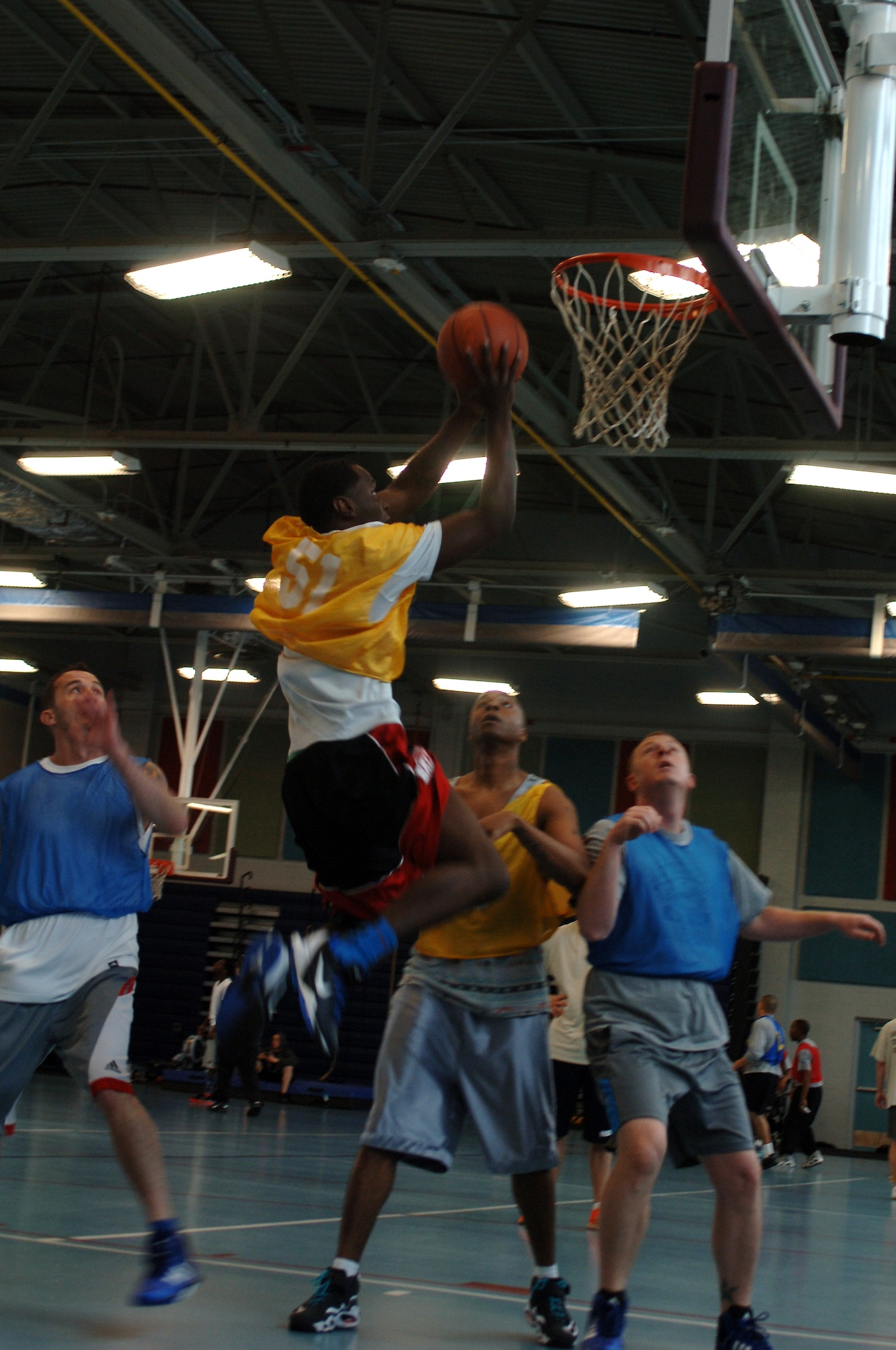 U.S. Army Pfc. Aramis McFarland, 558th Transportation Company, 10th Trans. Battalion, 7th Trans. Brigade (Expeditionary) automated logistics specialist, attempts a shot during a 3-on-3 basketball tournament at Fort Eustis, Va., April 19, 2014. More than thirty teams registered to play during the event, part of the installation’s Sexual Assault Awareness Month. (U.S. Air Force photo by Senior Airman Teresa J.C. Aber/Released)