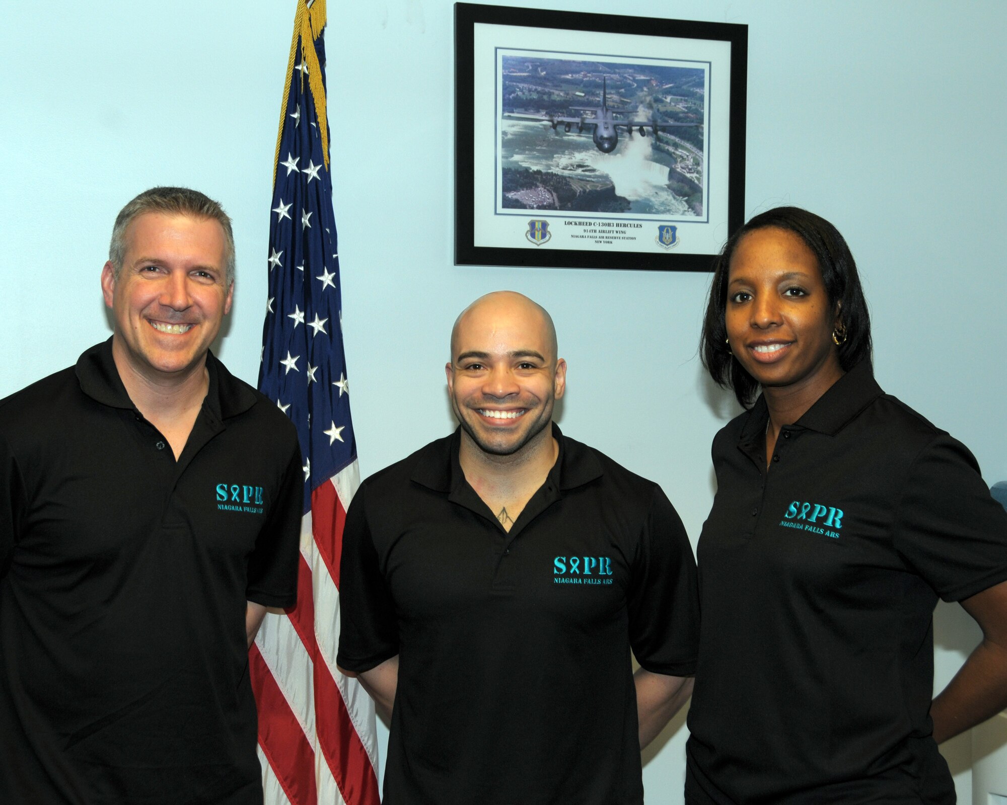 (L to R) SMSgt. Robert Denehy, Senior Air Force Reserve Recruiter, 914th Airlift Wing, TSgt. Alexander Pacheco, NCOIC 914th Development and Training Flight, and Ms. Nikki Slaughter Sexual Assault Response Coordinator, 914th Airlift Wing,  show off their Sexual Assault Prevention and Response polo shirts at the Niagara Falls Air Reserve Station, NY on April, 18, 2014.  These individuals were some of many who took part in activities at the base to help promote Sexual Assault Awareness Month (U.S. Air Force photo by Peter Borys)