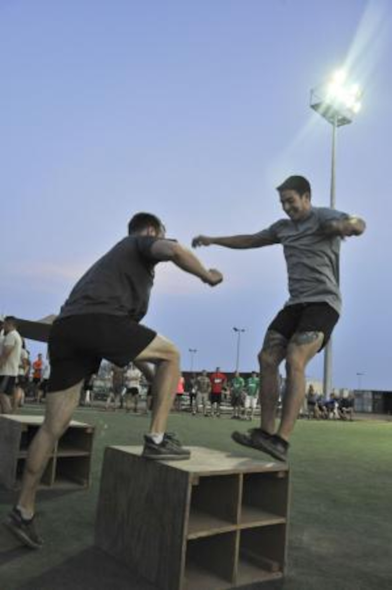 Matthew Gaddy, right, and Zach Hill, do box jumps during the Memorial Mash in memory of U.S. Air Force Chief Master Sgt. Nick McCaskill on Camp Lemonnier, Djibouti, April 6, 2014. Members of the 82nd Expeditionary Rescue Squadron (ERQS) organized the mash in remembrance of the one year anniversary of McCaskill’s death in Afghanistan. More than 70 people, split into 18 teams, competed in the event, which consisted of a total of 1,010 repetitions between 11 exercises. The repetitions symbolized McCaskill’s operating initials, a unique “XX.” Gaddy, a U.S. Air Force senior airman, and Hill, a technical sergeant, are both 82nd ERQS pararescuemen. (U.S. Air Force photo by Staff Sgt. Christopher Gross)