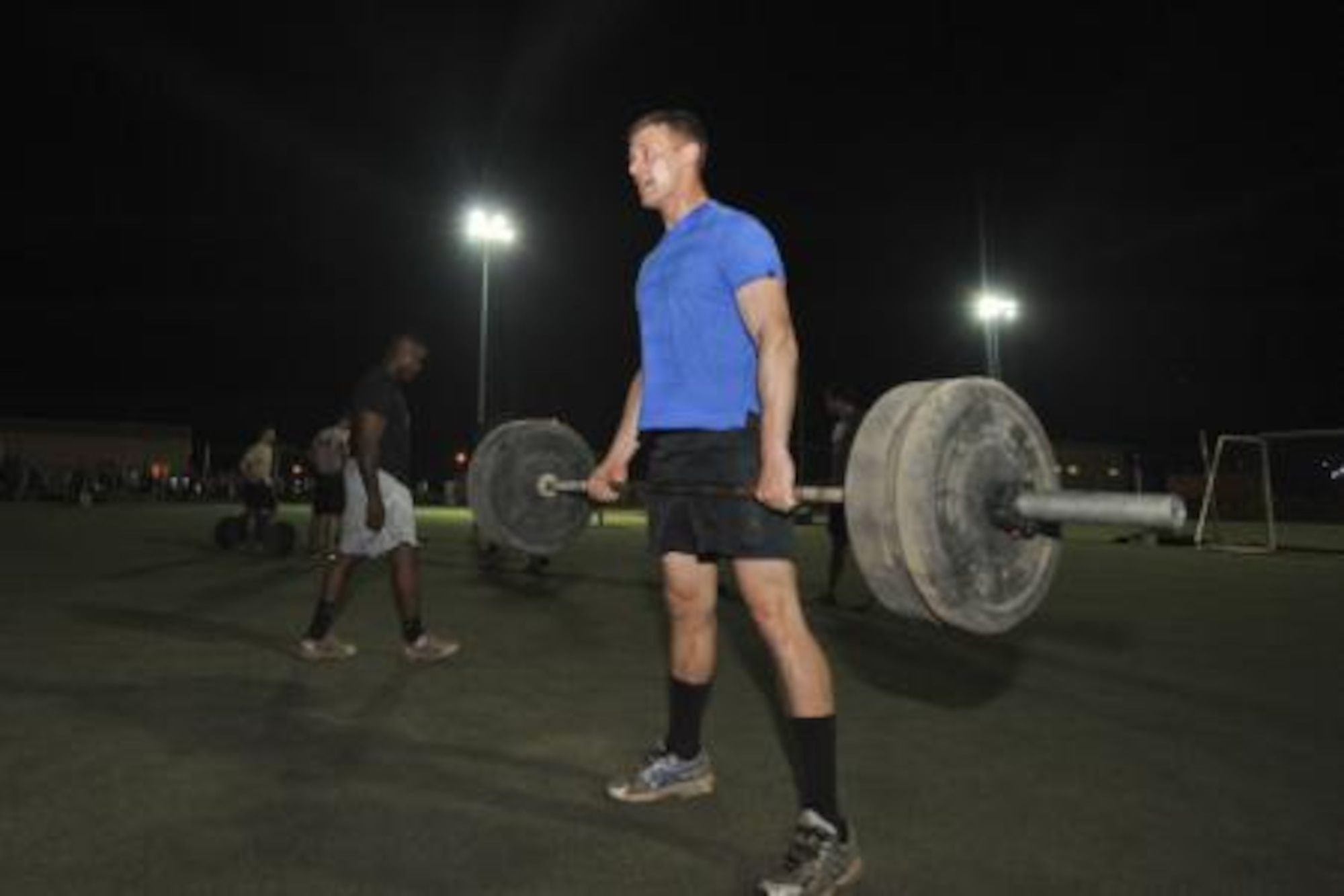 Eric Beougher performs a dead lift during the Memorial Mash in honor of U.S. Air Force Chief Master Sgt. Nick McCaskill on Camp Lemonnier, Djibouti, April 6, 2014. Members of the 82nd Expeditionary Rescue Squadron organized the mash in remembrance of the one year anniversary of McCaskill’s death in Afghanistan. More than 70 people, split into 18 teams, competed in the event, which consisted of a total of 1,010 repetitions between 11 exercises. The repetitions symbolized McCaskill’s operating initials, a unique “XX.” Beoughe, a U.S. Air Force airman first class, is a member of the 449th Air Expeditionary Group security forces detachment 1. (U.S. Air Force photo by Staff Sgt. Christopher Gross)