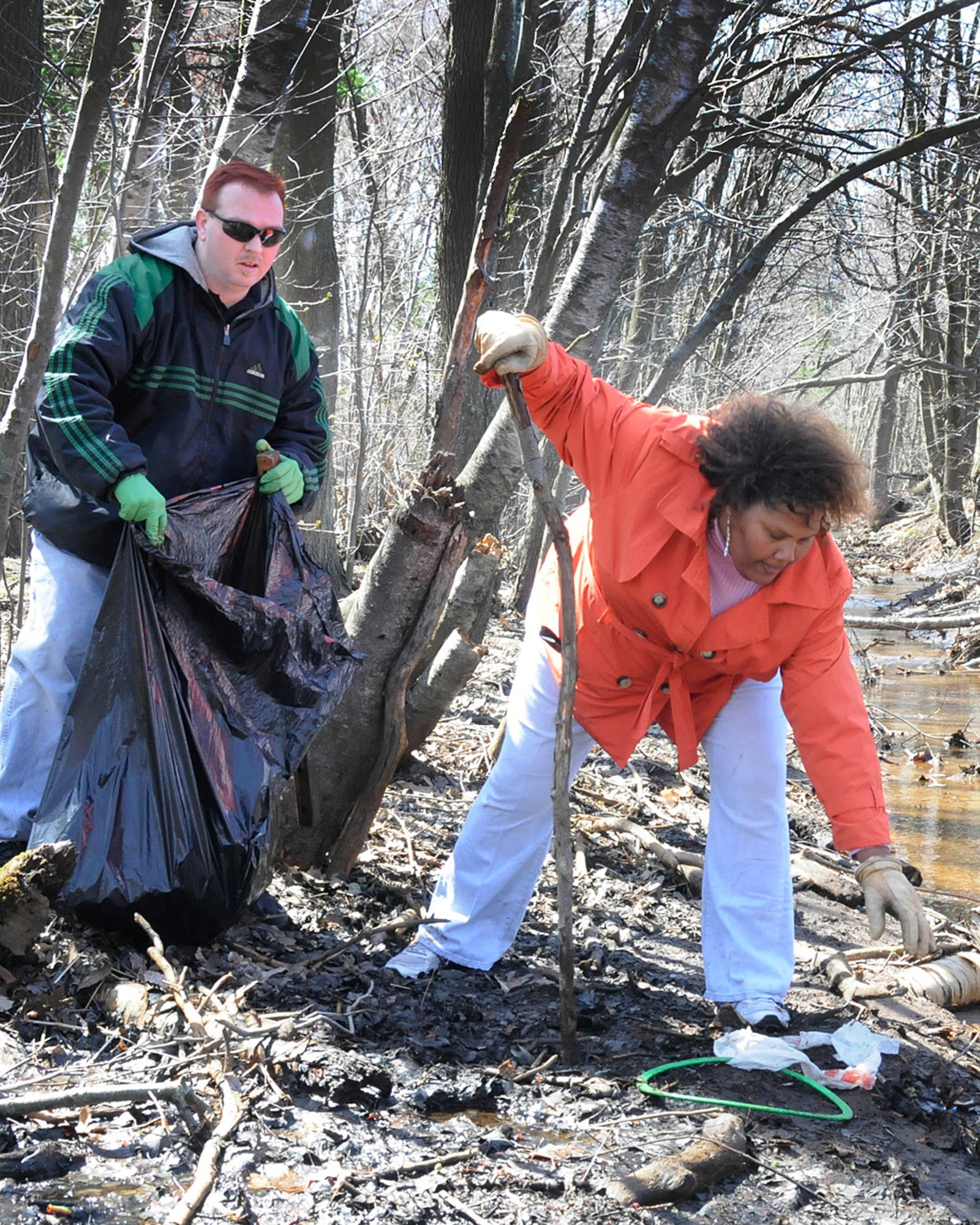 HANSCOM AIR FORCE BASE, Mass. – Melvinette McMillian and Anthony Wyman pull trash from the Shawsheen River during the base’s Earth Day Cleanup April 17. Volunteers from across the base took part in cleaning up Hanscom’s wetland and Shawsheen River areas. (U.S. Air Force photo by Linda LaBonte Britt)