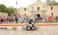502nd Civil Engineer Squadron Explosive Ordnance Disposal technicians from Joint Base San Antonio-Lackland use a robot to demonstrate methods of bomb disposal during San Antonio’s Fiesta 2014 Air Force Day at the Alamo April 21. Since its beginning in 1891, Fiesta’s focus is to honor to the heroes of the Alamo and the Battle of San Jacinto. (U.S. Air Force photo by Ben Faske)