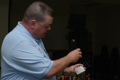 First Sgt. Danny Blackwell, Spartanburg County Sheriff's Office, shows 628th Security Forces Squadron Airmen how to check to see if an ID is fake, using their flashlights during the Project Star: Safety Through Alcohol Responsiblilty training April 18, 2014, at JB Charleston – Air Base, S.C. The training was designed to decrease the number of first-time alcohol-related incidents among underage military personnel on Join Base Charleston. (U.S. Air Force photo/ Airman Basic Chacarra Neal) 