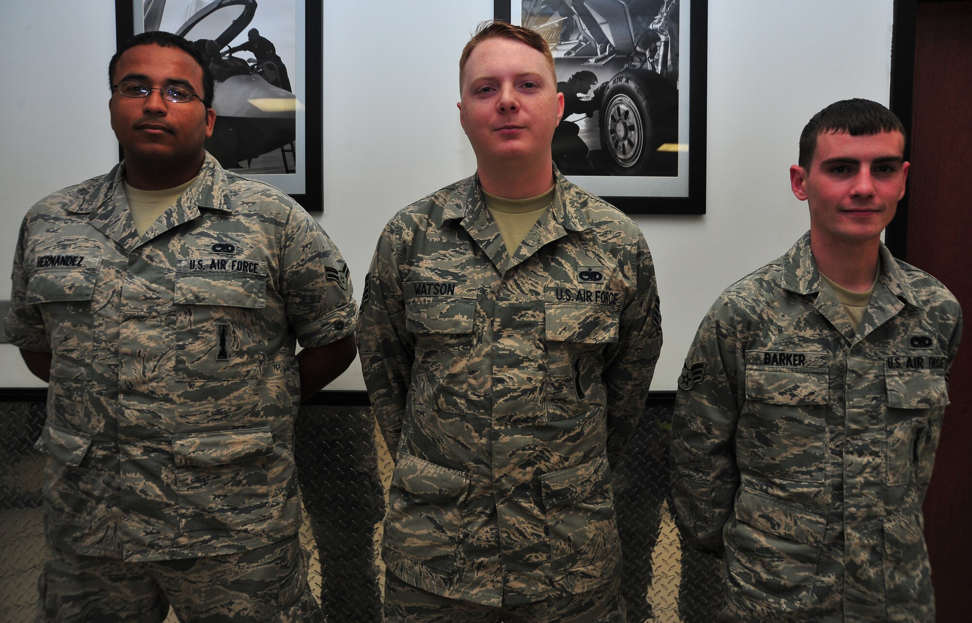 From left to right: Senior Airman Mario N. Hernandez III, 43rd Aircraft Munitions Unit F-22 weapons load crew member, Staff Sgt. Stephen R. Watson, 43rd AMU F-22 Raptor weapons load crew chief and Senior Airman Ryan C. Barker, 43rd AMU F-22 weapons load crew member, pose for a group picture April 21 at the 43rd AMU. They were the recipients of the Air Combat Command 2013 Weapons Load Crew of the Year award. (U.S. Air Force photo by Airman 1st Class Sergio Gamboa)