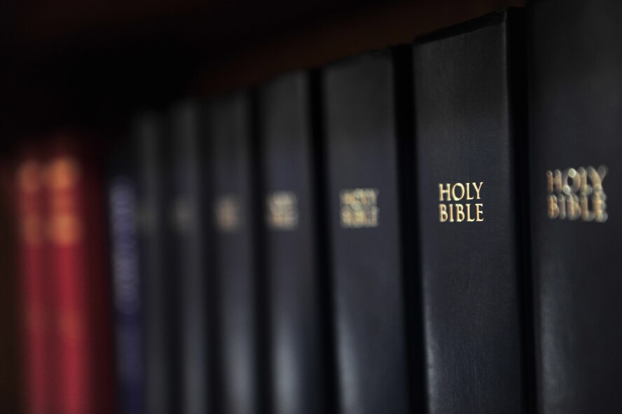 A row of Bibles sit on a bookshelf in a church at Minot Air Force Base, N.D., April 14, 2014. Chaplains work hard to help people directly, but they also assist Airmen with their presence itself. They also believe the simple act of being hands-on and doing what they do can make them a source of comfort. (U.S. Air Force photo/Senior Airman Malia Jenkins)