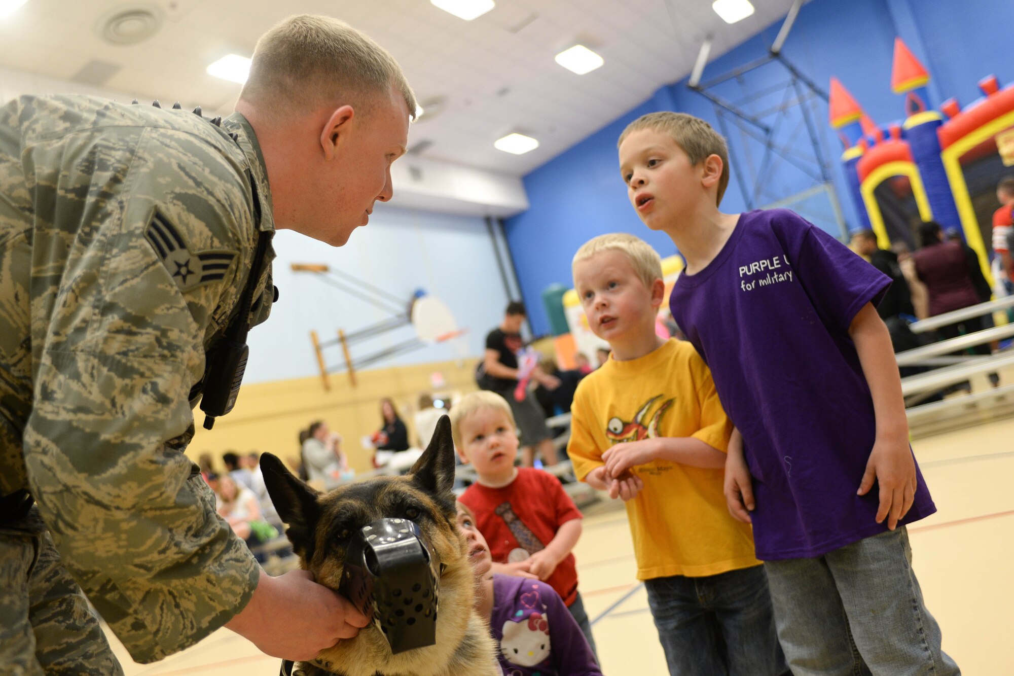 Senior Airman Jared Phillips, 28th Security Forces Squadron military working dog handler, introduces his partner Rex to children of Airmen during a Month of the Military Child celebration event held in the Youth Center at Ellsworth Air Force Base, S.D., April 12, 2014. The event provided an opportunity for Airmen from a variety of career fields to interact with to military children and explain the importance of their parent’s work in the Air Force. (U.S. Air Force photo by Senior Airman Zachary Hada/Released)