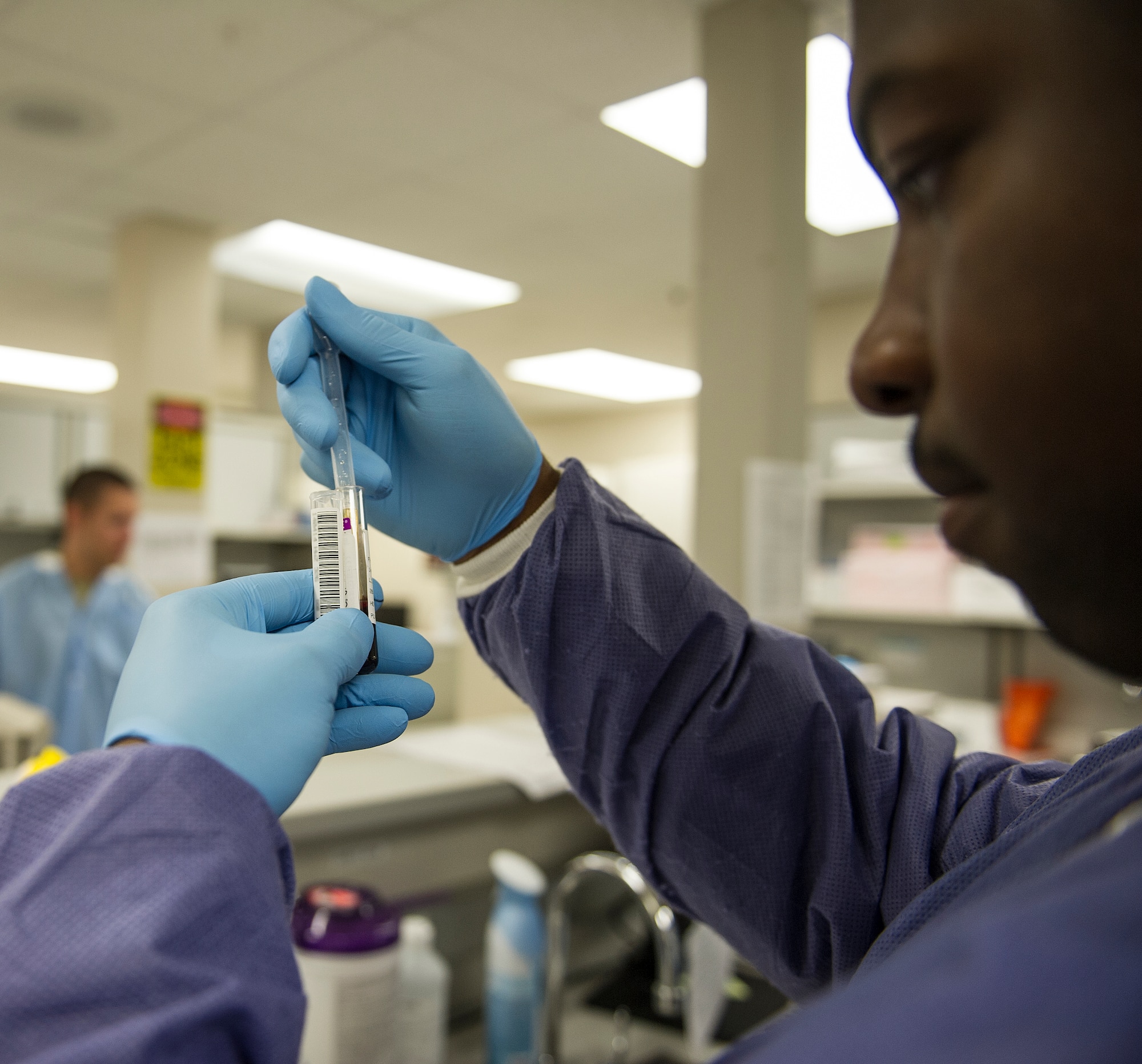 Airman 1st Class Roger Smith III, 1st Special Operations Medical Support Squadron medical laboratory technician, performs a blood chemistry test at Hurlburt Field, Fla., April 14, 2014. Medical lab techs perform tests on blood, urine and other samples collected from patients to help doctors diagnose illnesses and diseases. (U.S. Air Force photo/Airman 1st Class Jeff Parkinson)