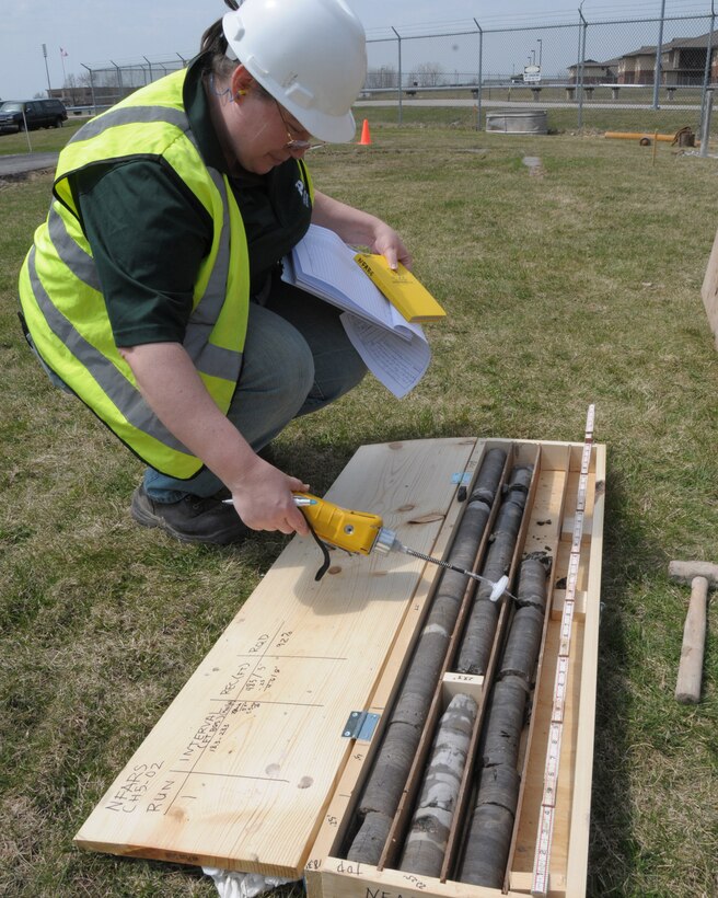 A senior geologist with EA Science and Technology screens the core samples and classifies any organic volatiles at the Niagara Falls Air Reserve Station, N.Y. on April 21, 2014. The contractor is preforming a pre design investigation to help reduce environmental contamination. (U.S. Air Force photo by Peter Borys)