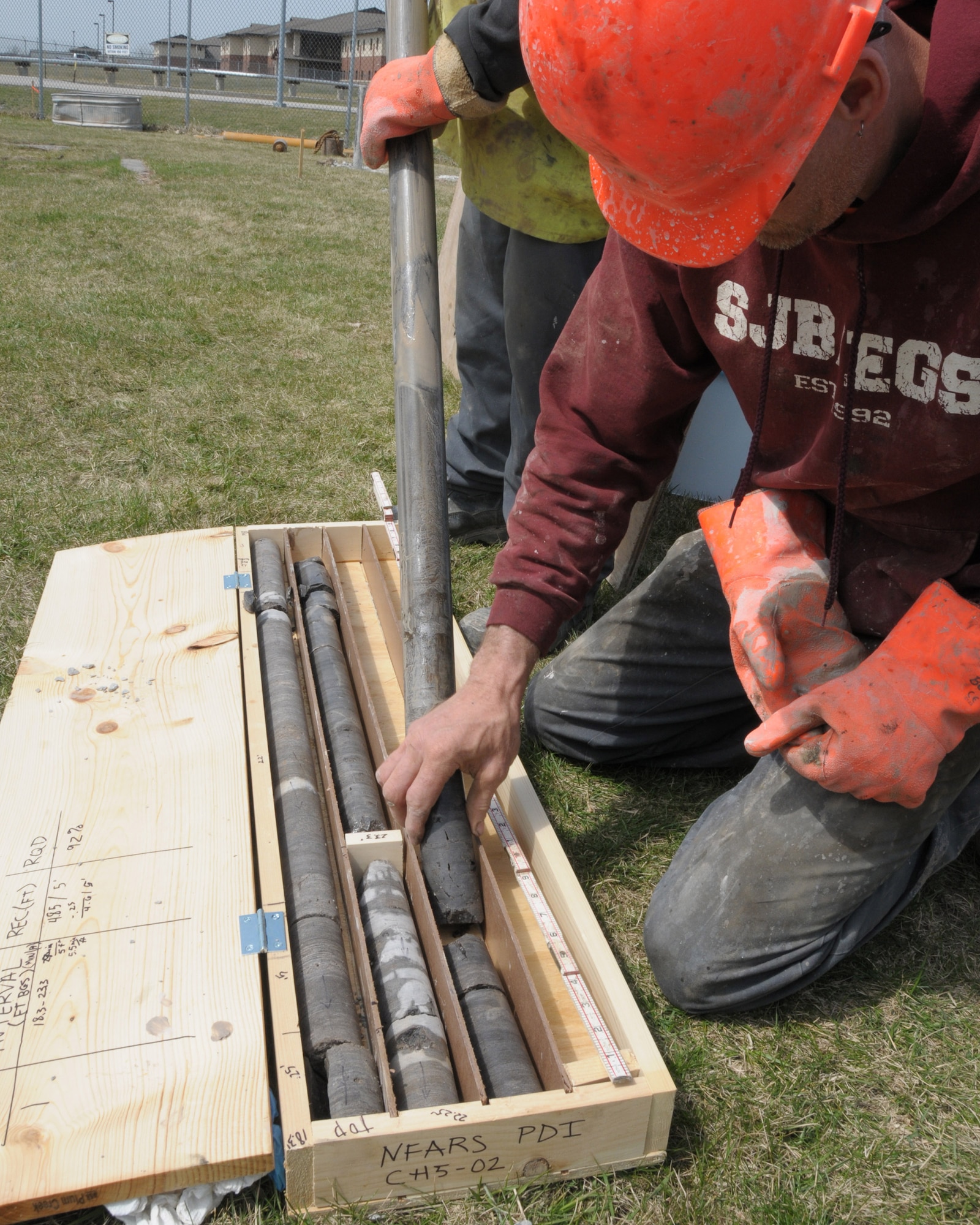 Workers from EA Engineering P.C. and its affiliate EA Science and Technology place soil borings into a crate at the Niagara Falls Air Reserve Station, N.Y. on April 21, 2014. The contractor is preforming a pre design investigation to help reduce environmental contamination. (U.S. Air Force photo by Peter Borys)