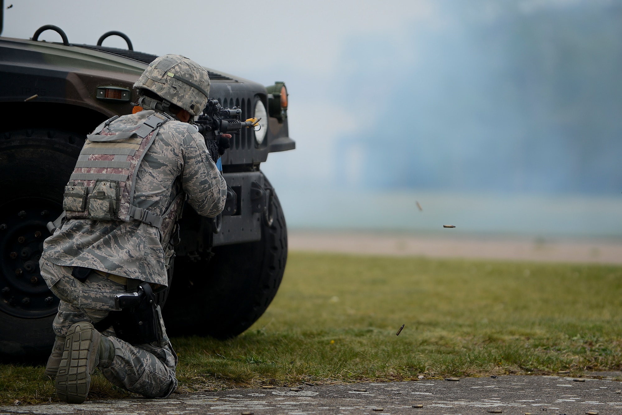 Senior Airman Issac Rhee, 48th Security Forces Squadron response force member, defends the crash scene during a combat search and rescue exercise at Royal Air Force Lakenheath, England, April 17, 2014. The rescue mission scenario included pararescue and security forces teams recovering a victim injured by an improvised explosive device. (U.S. Air Force photo by Airman 1st Class Trevor T. McBride/Released)