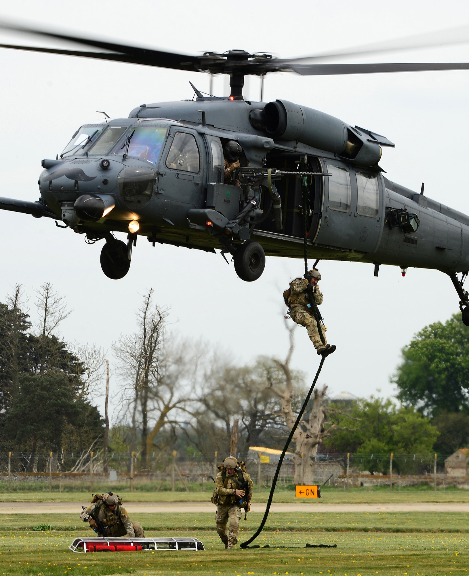 A 56th Rescue Squadron pararescue team deploys with equipment from an HH-60G Pave Hawk during a combat search and rescue exercise at Royal Air Force Lakenheath, England, April 17, 2014. The rescue mission scenario included pararescue and security forces teams recovering a victim injured by an improvised explosive device. (U.S. Air Force photo by Staff Sgt. Emerson Nuñez/Released)