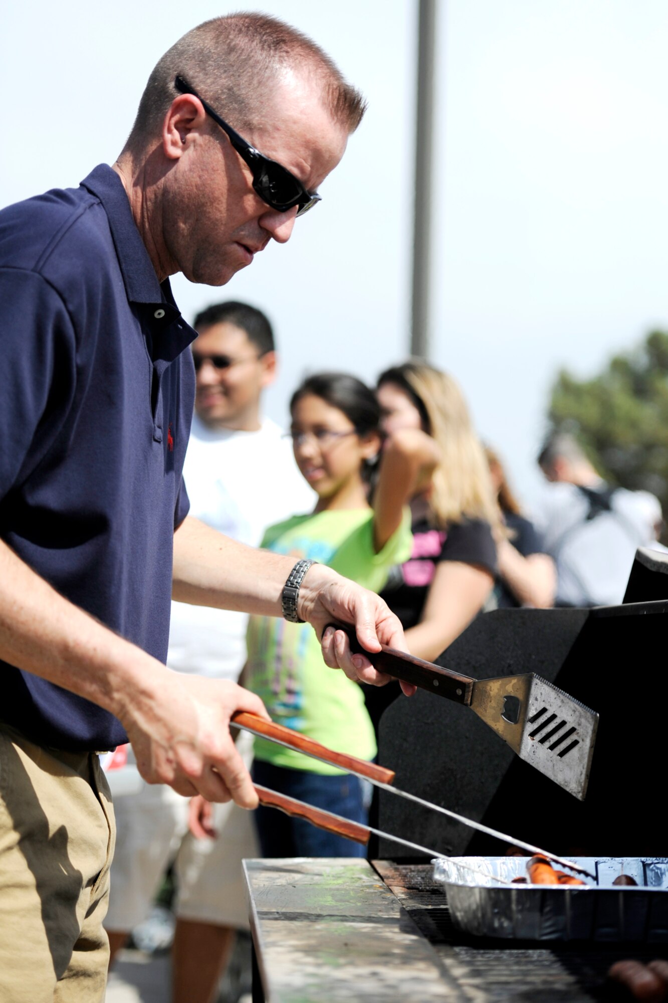 GOODFELLOW AIR FORCE BASE, Texas-- Senior Master Sgt. James T. Baxley, 17th Medical Group first sergeant, cooks hot dogs during the Month of the Military Child Spring Fling here April 12. Volunteers helped set up, run events and cook food. (U. S. Air Force photo/ Staff Sgt. Austin Knox)
