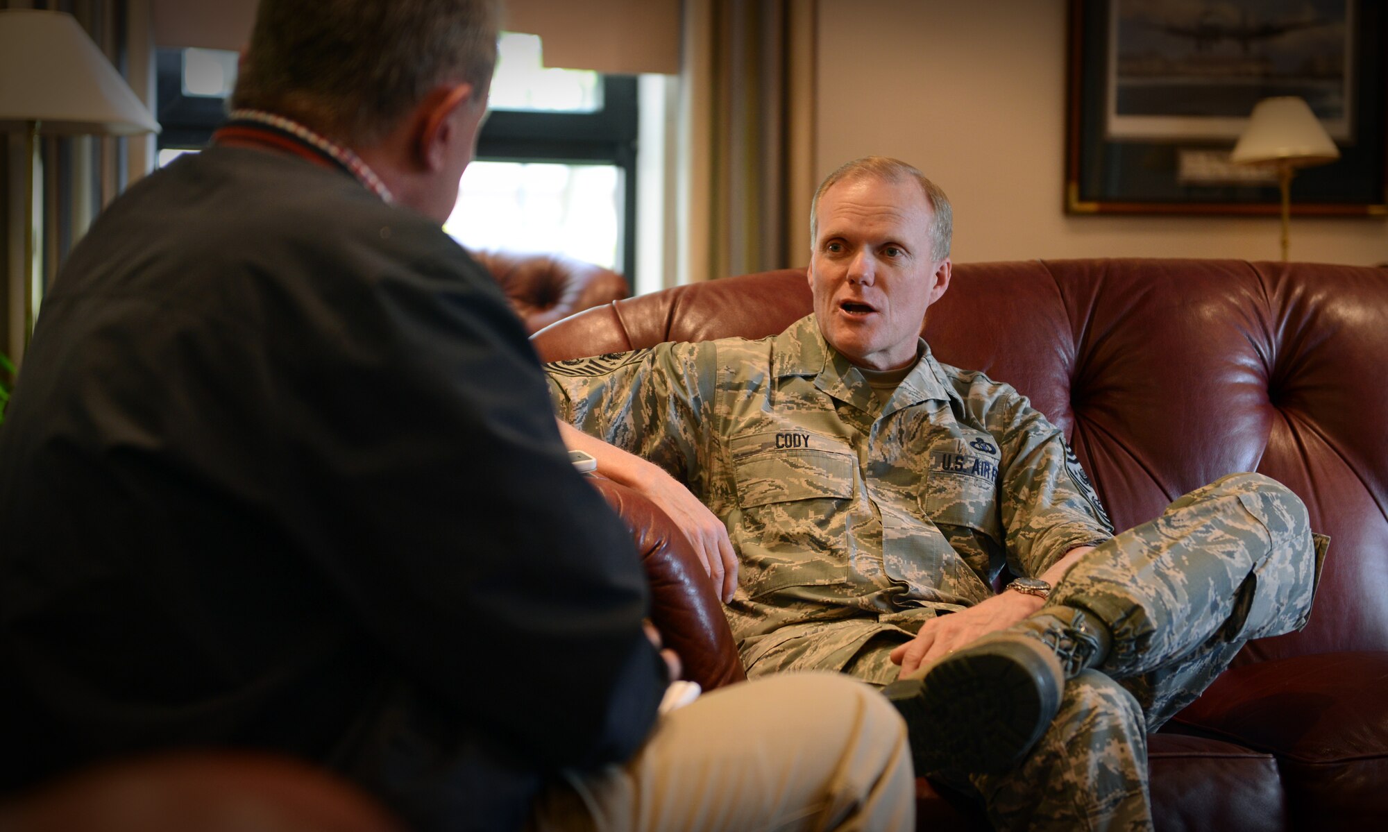 Chief Master Sgt. of the Air Force, James A. Cody, speaks with Slobodan Lekic, Stars and Stripes reporter, April 18, 2014, during a brief stopover at Ramstein Air Base, Germany on his way home after a week-long trip to Afghanistan. Cody toured various bases in Afghanistan to speak to Airmen about their contributions to the mission and experiences working with their Afghan counterparts. (U.S. Air Force photo/ Staff Sgt. Ryan Crane)