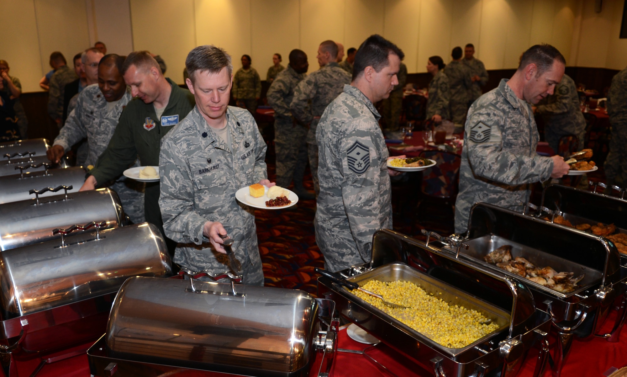 Team Mildenhall leaders, Sexual Assault Prevention and Response office members and Air Force Office of Special Investigations members get food from a buffet April 22, 2014, during a military justice and SAPR forum on RAF Mildenhall, England. The forum allowed Team Mildenhall members to learn about recent changes in military law and discuss its impact on the RAF Mildenhall mission. (U.S. Air Force photo by Airman 1st Class Dillon Johnston/Released)