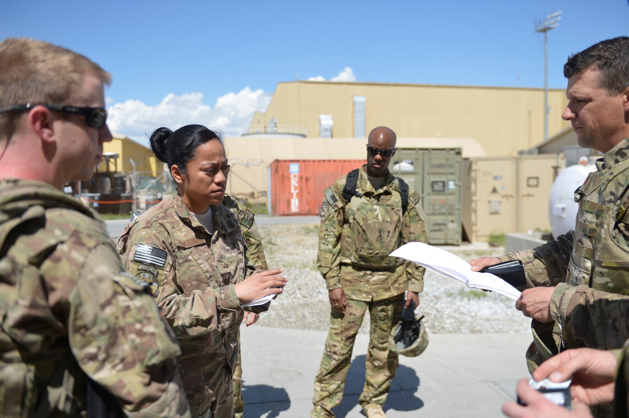 U.S. Air Force Senior Airman Desirae Faasavalu provides information to Airmen arriving at Bagram Airfield, Afghanistan, April 17, 2014. Faasavalu is assigned to the 455th PERSCO (Personnel Support for Contingency Operations) team, and was meeting personnel as they arrived at the passenger terminal from an inbound flight.(U.S. Air Force photo by Senior Master Sgt. Gary J. Rihn/Released)  