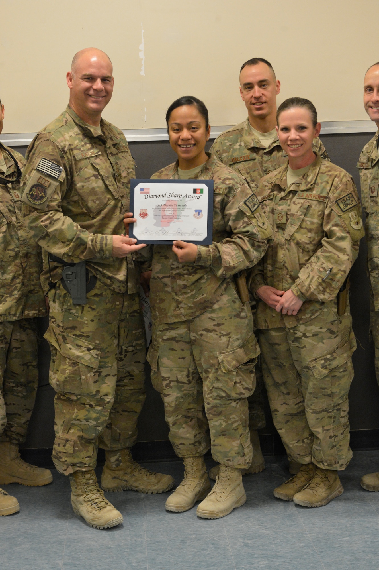 U.S. Air Force Senior Airman Desirae Faasavalu receives the Diamond Sharp award from the First Sergeants Council at Bagram Airfield, Afghanistan, April 17, 2014. Faasavalu is assigned to the 455th PERSCO (Personnel Support for Contingency Operations) team, and was recognized as part of the team for her outstanding performance during processing of Airmen at Bagram.(U.S. Air Force photo by Senior Master Sgt. Gary J. Rihn/Released)  