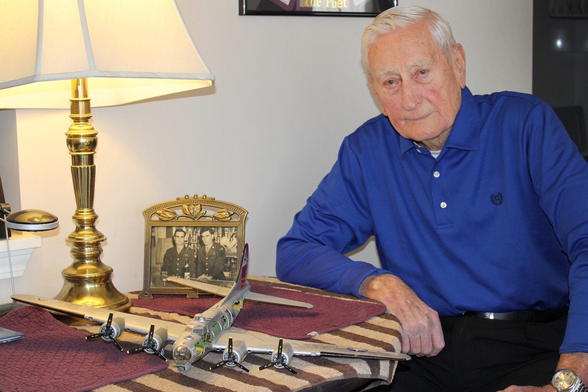 140401-Z-VA676-004 -- Alfred P. Murphy will be awarded the Distinguished Flying Cross for his service with a B-17 Flying Fortress flight crew, a model of which is on the table, during World War II. Murphy uses the model in his visits to local schools to explain the workings of the aircraft and its crew. In the background is a photo of Murphy with his late brother, William, who also served as an enlisted flight crew member during the war, first on a B-17 and later on a C-54 Skymaster. (U.S. Air National Guard photo by TSgt. Dan Heaton/Released)