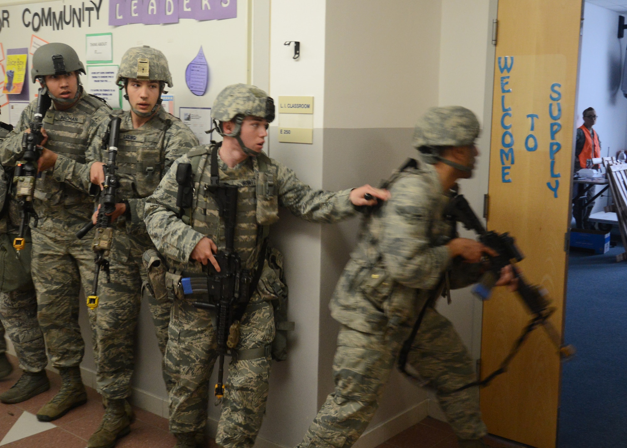 A team of 31st Security Forces Squadron defenders clear a classroom during an active shooter training exercise at the Aviano Air Base Elementary School, April 19, 2014. The SFS Airmen culminated their week-long active shooter training with a hands-on exercise that tested their abilities to respond in a stressful situation. The Airmen had the opportunity to practice self-aid and buddy care and close quarter battle during the day long exercise. (U.S. Air Force photo/Tech. Sgt. Eric Donner)
