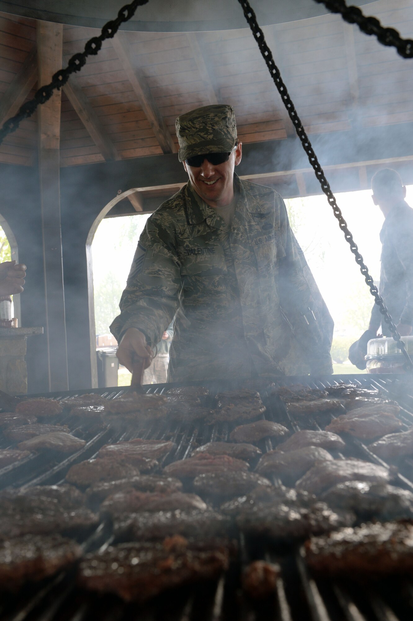 U.S. Air Force Master Sgt. Donald Valentine, 52nd Fighter Wing Inspector General complaint resolution director from Sandusky, Ohio, flips burger patties during a base-wide cookout at the wing pavilion on Spangdahlem Air Base, Germany, April 18, 2014. Spangdahlem’s men and women’s groups, The Roundtable and Spangdamen, worked the cookout as part of the wing’s Sexual Assault Prevention and Response down day. (U.S. Air Force photo by Staff Sgt. Chad Warren/Released)
