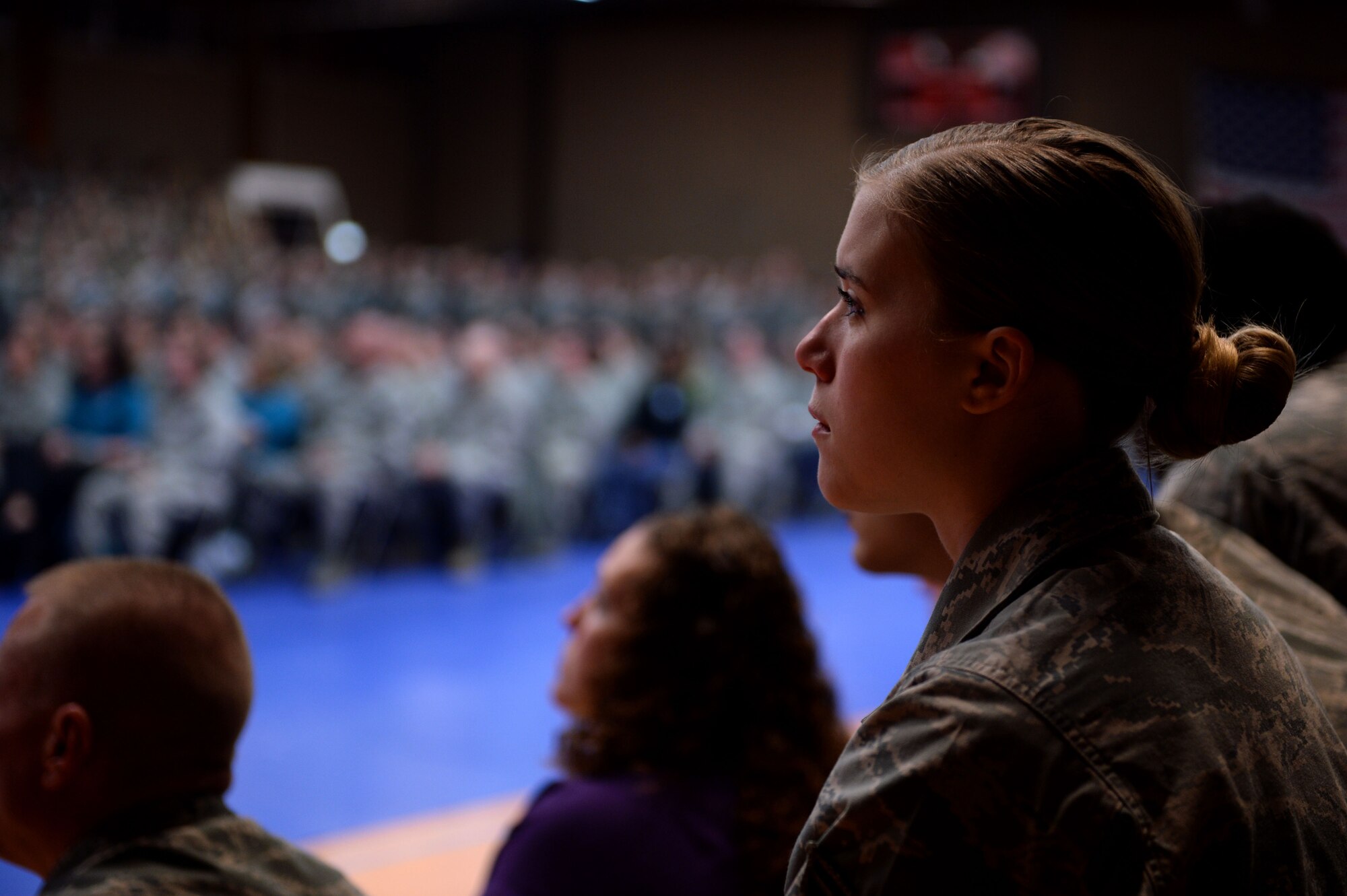 U.S. Air Force Airman 1st Class Alissa Rogers, a 52nd Force Support Squadron food shift leader from Medford, Minn., watches a video on sexual assault during an all call at the Skelton Memorial Fitness Center on Spangdahlem Air Base, Germany, April 18, 2014. The Sexual Assault Prevention and Response down day served as the first of two on ridding the Air Force of sexual assault. The wing will participate in a second down day this fall. (U.S. Air Force photo by Senior Airman Alexis Siekert/Released)