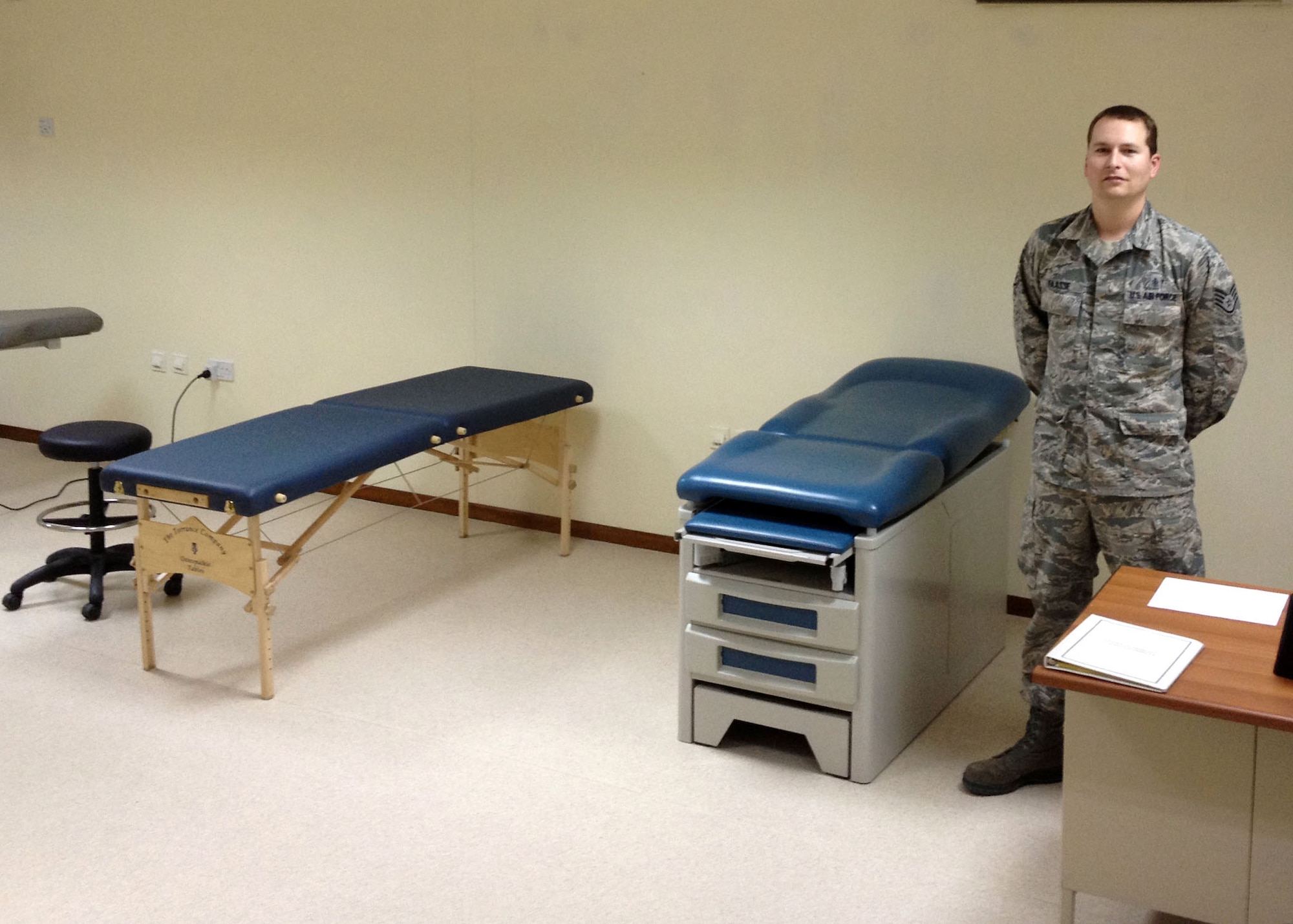 Air Force Staff Sgt. Zach Faasse, 380th Expeditionary Medical Group physical therapy technician, stands near physical therapy equipment used in the recently opened 380th Air Expeditionary Wing physical therapy clinic. (Courtesy photo)