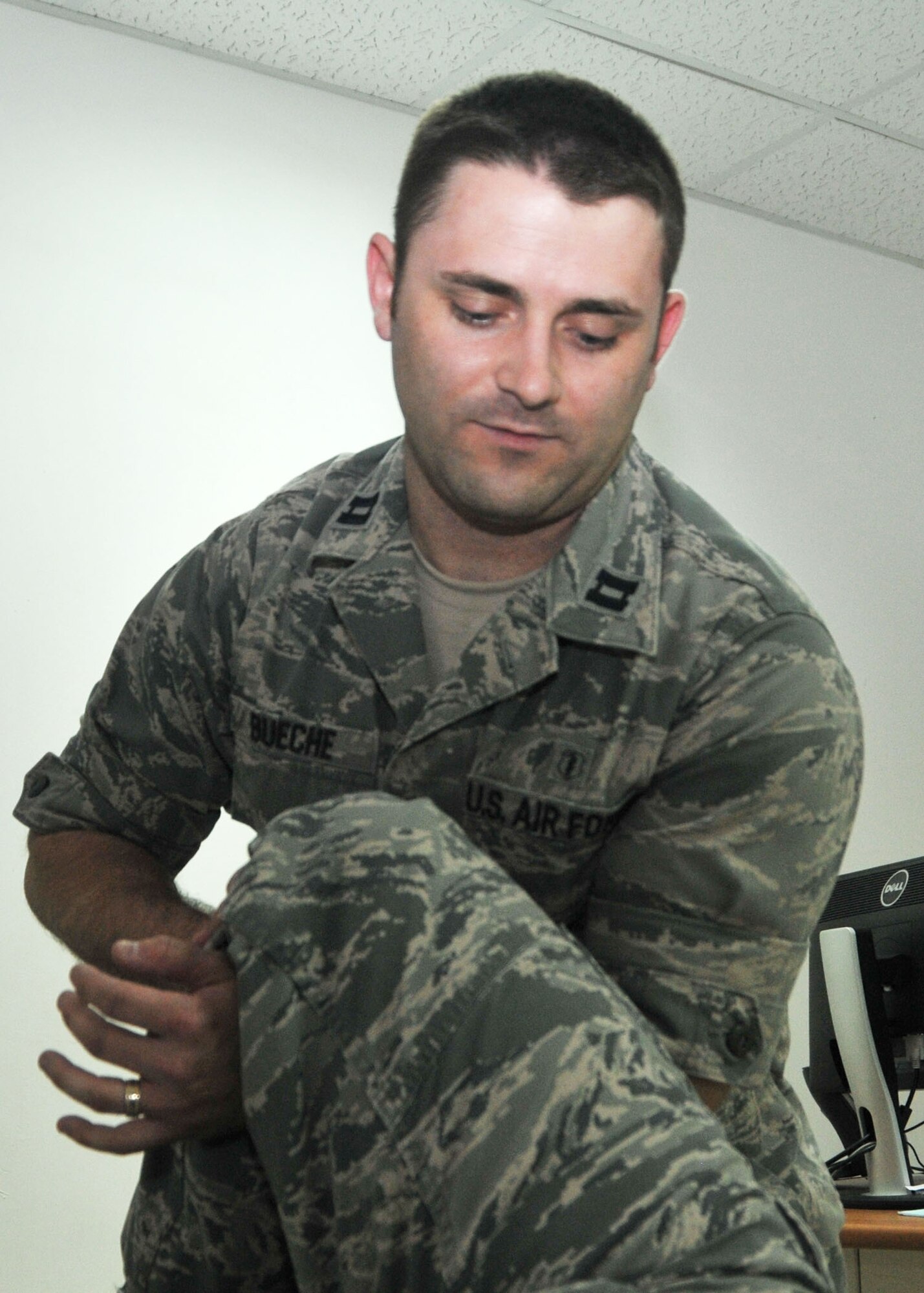 Air Force Capt. Jared P. Bueche, 380th Expeditionary Medical Group physical therapist, demonstrates a treatment technique on a volunteer from the 380 EMG. Bueche is the first physical therapist to offer clinical services at the 380th Air Expeditionary Wing. (U.S. Air Force photo by Senior Master Sgt. Eric Peterson)