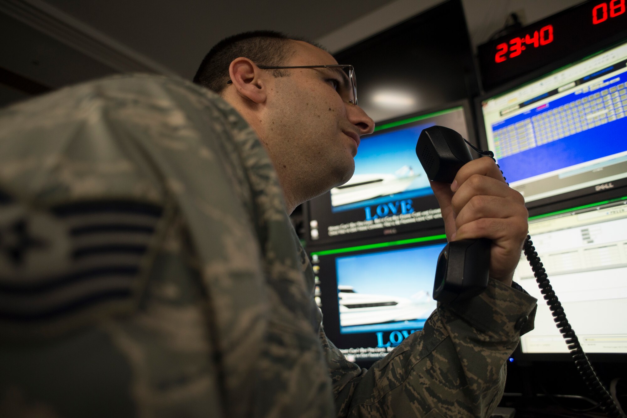 Tech. Sgt. Sean Clark, 374th Maintenance Group senior weapons systems controller, coordinates information with an Airman at Yokota Air Base, Japan, April 18, 2014. Clark works in the maintenance operations center and is tasked with disseminating and documenting pre-flight operations and maintenance taking place on C-130H Hercules. (U.S. Air Force photo by Staff Sgt. Cody H. Ramirez/Released)