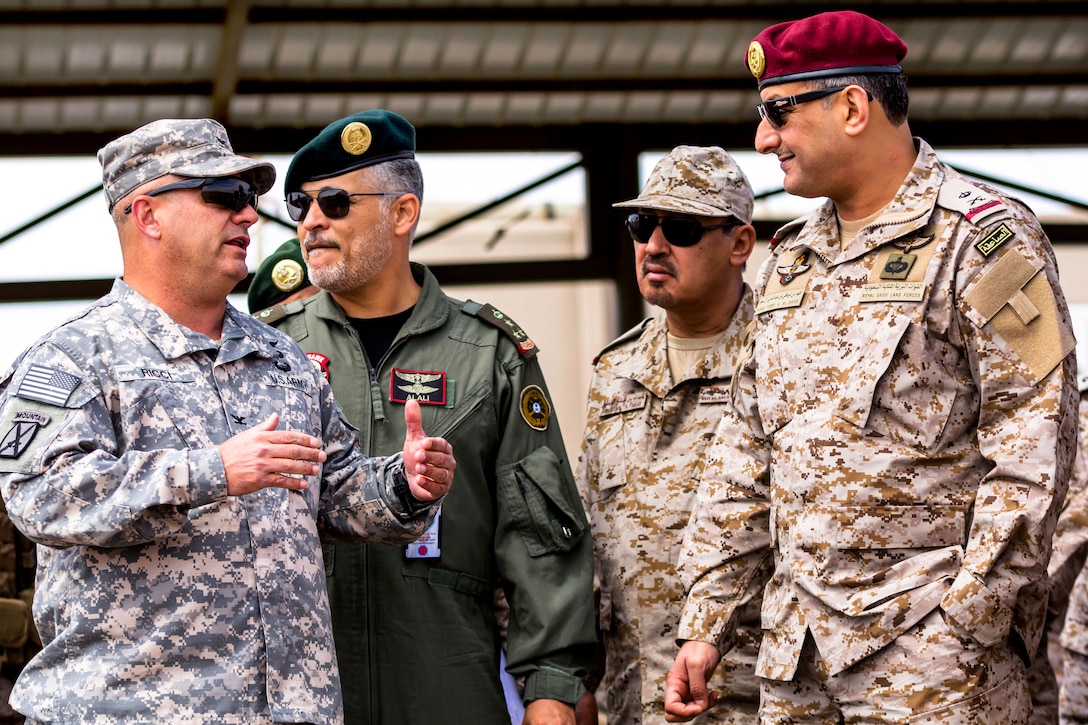 U.S. Army Col. Albert J. Ricci Sr., left, speaks to Maj. Gen. Prince Fahad bin Turki Abdulaziz Al-Saud of the Saudi land forces during Exercise Friendship and Iron Hawk 14 near Tabuk, Saudi Arabia, April 10, 2014. The exercise spotlights improved tactical cooperation between U.S. and Saudi forces. Ricci commands the 42nd Combat Aviation Brigade.