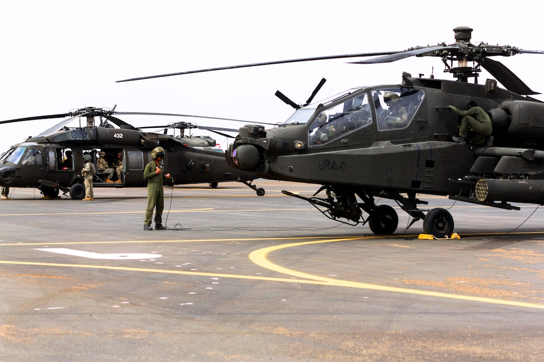 U.S. soldiers prepare AH-64 Apache and UH-60 Black Hawk helicopters before a practice joint air assault exercise with Saudi soldiers near Tabuk, Saudi Arabia, April 12, 2014.