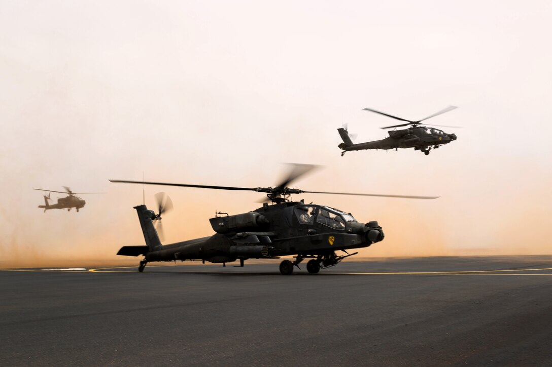 U.S. AH-64 Apache helicopters take off for a joint exercise with Saudi soldiers near Tabuk, Saudi Arabia, April 12, 2014.