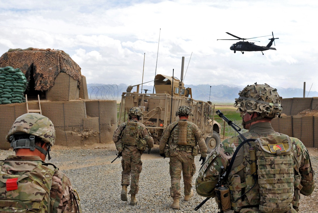 U.s. Soldiers Walk Toward A Uh-60 Black Hawk Helicopter After A 