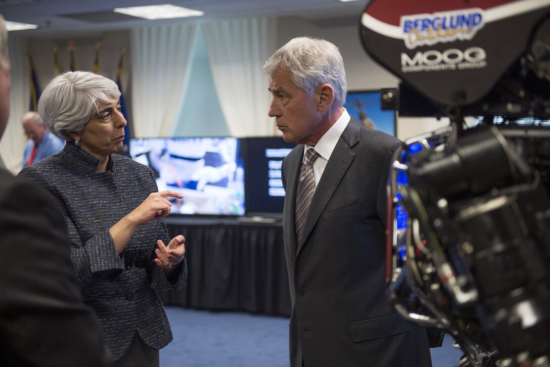 Arati Prabhakar, the director of the Defense Advanced Research Projects Agency, or DARPA, briefs Defense Secretary Chuck Hagel on the Atlas robot and other robotics at the Pentagon, April 22, 2014. 