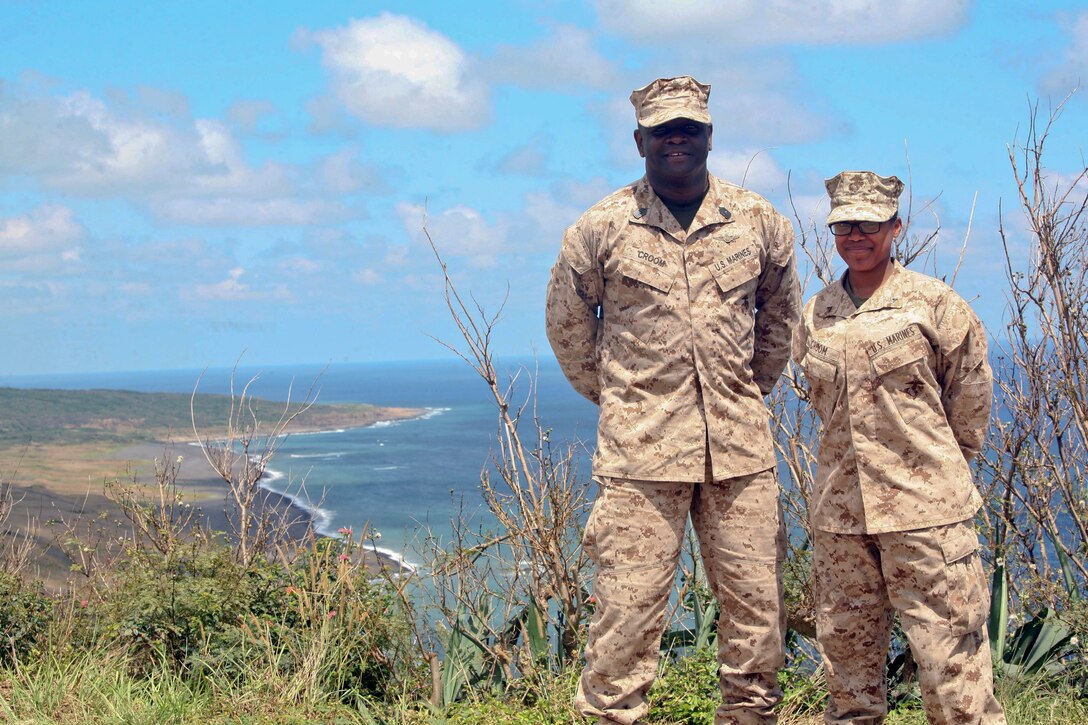 Master Gunnery Sgt. Corey L. Croom, left, and his daughter Lance Cpl. Chesney A. Croom pose for a photo at the summit of Mount Suribachi April 11 during a professional military education tour to Iwo To, formerly known as Iwo Jima. “It’s surreal because, in 26 years, I never pictured myself getting an opportunity to even land on Iwo To,” said Corey Croom. “To experience this with my oldest daughter, who happens to be a lance corporal in the United States Marine Corps, is (even more unique).” Corey Croom is the operations noncommissioned officer in charge with Marine Wing Headquarters Squadron 1, 1st Marine Aircraft Wing, III Marine Expeditionary Force, and Chesney Croom is a logistics embarkation clerk with MWHS-1, 1st MAW, III MEF. (U.S. Marine Corps photo by Sgt. Anthony J. Kirby/RELEASED)