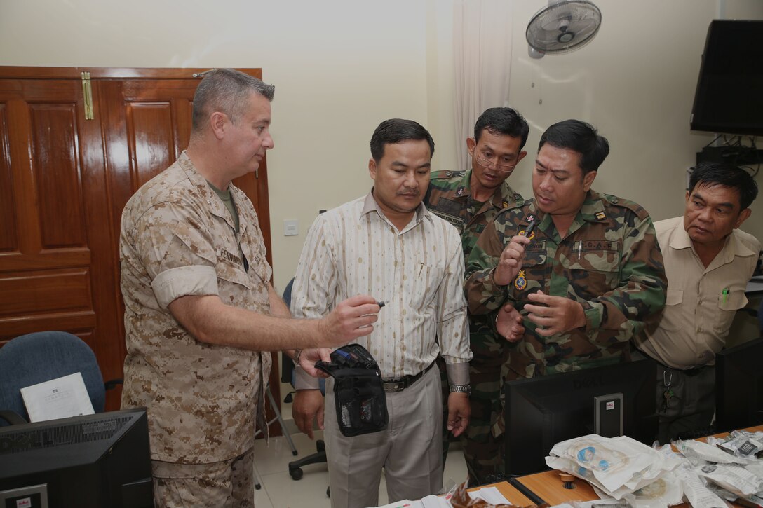 U.S. Navy Cmdr. Alberto Fernandez-Milo, left, shows Cambodia military medical personnel how to use an “ear, nose and throat” kit during a practical application seminar March 20 as part of Cambodia Medical Exercise 14-1 in Phnom Penh, Cambodia. The seminar is part of a weeklong medical subject-matter expert exchange focused on preparing and planning for humanitarian assistance and disaster relief efforts. During the seminar, participants learned how to properly use and improvise certain medical equipment, such as tourniquets, to better support first aid and triage procedures. Fernandez-Milo is a psychiatrist with 4th Medical Battalion, 4th Marine Logistics Group, U.S. Marine Corps Forces Reserve. 