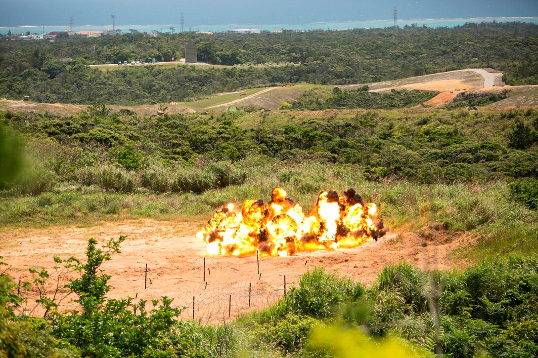 A ring of TNT explodes April 15 during a four-day basic demolition training course at Camp Schwab. The controlled explosion allowed Marines to observe how effectively the blast demolished obstacles. The Marines participating in the training are with various units assigned to III Marine Expeditionary Force. 