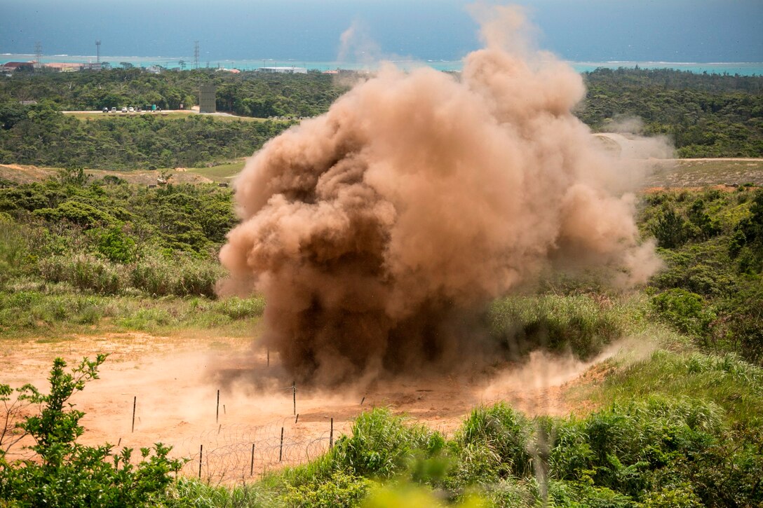 A ring of TNT explodes April 15 during a four-day basic demolition training course at Camp Schwab. The controlled explosion allowed Marines to observe how effectively the blast demolished obstacles. The Marines participating in the training are with various units assigned to III Marine Expeditionary Force. 