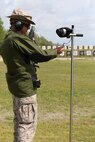 Col. Gregory H. Kitchens, officer in charge and marksmanship training unit and shooting for Marine Corps Forces Reserve Division Team, checks his time before firing the National Match M16A4 service rifle with iron sights at the 200-yard line during the individual rifle portion of the 2014 Marine Corps Championships from April 14-16 aboard the Weapons Training Battalion ranges at Stone Bay. Kitchens is one of 84 competitors, and they competed in three different categories. The individual rifle match, the individual pistol match and the team rifle and pistol match. The individual rifle match and team match are shot from the 200-yard line, 300-yard line and 600-yard line. The match rifle weighs approximately 17 pounds, with a stainless steel barrel with both weighted hand guards and butt stock. During competition marksmanship, competitors are supplied with unique shooting jackets and non-slip leather rifle slings that provide additional stability, and long-distance scouting scopes to sight shots at distances more than 600 yards. (U.S. Marine Corps photo by Sgt. Alicia R. Leaders/Released)