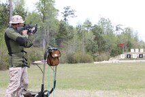 Sgt. Richard N. West, a drill instructor from Marine Corps Recruit Depot Parris Island, S.C., Eastern Division Team, fires the National Match M16A4 service rifle with iron sights at the 200-yard line during the individual rifle portion of the 2014 Marine Corps Championships from April 14-16 aboard the Weapons Training Battalion ranges at Stone Bay. West is one of 84 competitors, and they competed in three different categories. The individual rifle match, the individual pistol match and the team rifle and pistol match. The individual rifle match and team match are shot from the 200-yard line, 300-yard line and 600-yard line. The match rifle weighs approximately 17 pounds, with a stainless steel barrel with both weighted hand guards and butt stock. During competition marksmanship, competitors are supplied with unique shooting jackets and non-slip leather rifle slings that provide additional stability, and long-distance scouting scopes to sight shots at distances more than 600 yards. (U.S. Marine Corps photo by Sgt. Alicia R. Leaders/Released)