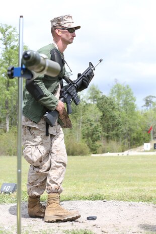 Cpl. Austin J. Kirby, an Aircraft Rescue and Fire Fighting technician with Marine Wing Support Detachment, Marine Corps Air Station Kaneohe Bay, Hawaii, Pacific Division Team, stands in preparation for moving to the sitting position upon firing the National Match M16A4 service rifle with iron sights at the 300-yard line rapid fire during the individual rifle portion of the 2014 Marine Corps Match Championships from April 14-16 aboard the Weapons Training Battalion ranges at Stone Bay. Kirby is one of 84 competitors, and they competed in three different categories. The individual rifle match, the individual pistol match and the team rifle and pistol match. The individual rifle match and team match are shot from the 200-yard line, 300-yard line and 600-yard line. The match rifle weighs approximately 17 pounds, with a stainless steel barrel with both weighted hand guards and butt stock. During competition marksmanship, competitors are supplied with unique shooting jackets and non-slip leather rifle slings that provide additional stability, and long-distance scouting scopes to sight shots at distances more than 600 yards. (U.S. Marine Corps photo by Sgt. Alicia R. Leaders/Released)