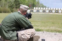 Cpl. Austin J. Kirby, an Aircraft Rescue and Fire Fighting technician with Marine Wing Support Detachment, Marine Corps Air Station Kaneohe Bay, Hawaii, Pacific Division Team, fires the National Match M16A4 service rifle with iron sights at the 300-yard line rapid fire during the individual rifle portion of the 2014 Marine Corps Match Championships from April 14-16 aboard the Weapons Training Battalion ranges at Stone Bay. Kirby is one of 84 competitors, and they competed in three different categories. The individual rifle match, the individual pistol match and the team rifle and pistol match. The individual rifle match and team match are shot from the 200-yard line, 300-yard line and 600-yard line. The match rifle weighs approximately 17 pounds, with a stainless steel barrel with both weighted hand guards and butt stock. During competition marksmanship, competitors are supplied with unique shooting jackets and non-slip leather rifle slings that provide additional stability, and long-distance scouting scopes to sight shots at distances more than 600 yards. (U.S. Marine Corps photo by Sgt. Alicia R. Leaders/Released)