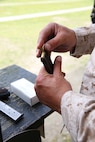 Sgt. Richard N. West, a drill instructor from Marine Corps Recruit Depot Parris Island, S.C., Eastern Division Team, loads a magazine in preparation for firing the National Match M1911 .45 caliber service pistol during the individual pistol portion of the 2014 Marine Corps Match Championships from April 14-16 aboard the Weapons Training Battalion ranges at Stone Bay. The individual pistol match is shot at the 25-yard line and 50-yard line, and must be shot one-handed. West is one of 84 competitors, and they competed in three different categories. The individual rifle match, the individual pistol match and the team rifle and pistol match. (U.S. Marine Corps photo by Sgt. Alicia R. Leaders/Released)
