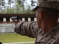 Lance Cpl. Branden A. Debolt, a TOW gunner with 1st Tank Battalion, 1st Marine Division, Marine Corps Air Ground Combat Center Twentynine Palms, Calif., Western Division Team, fires the National Match M1911 .45 caliber service pistol during the individual pistol portion of the 2014 Marine Corps Championships from April 14-16 aboard the Weapons Training Battalion ranges at Stone Bay. The individual pistol match is shot at the 25-yard line and 50-yard line, and must be shot one-handed. Debolt is one of 84 competitors, and they competed in three different categories. The individual rifle match, the individual pistol match and the team rifle and pistol match. (U.S. Marine Corps photo by Sgt. Alicia R. Leaders/Released)