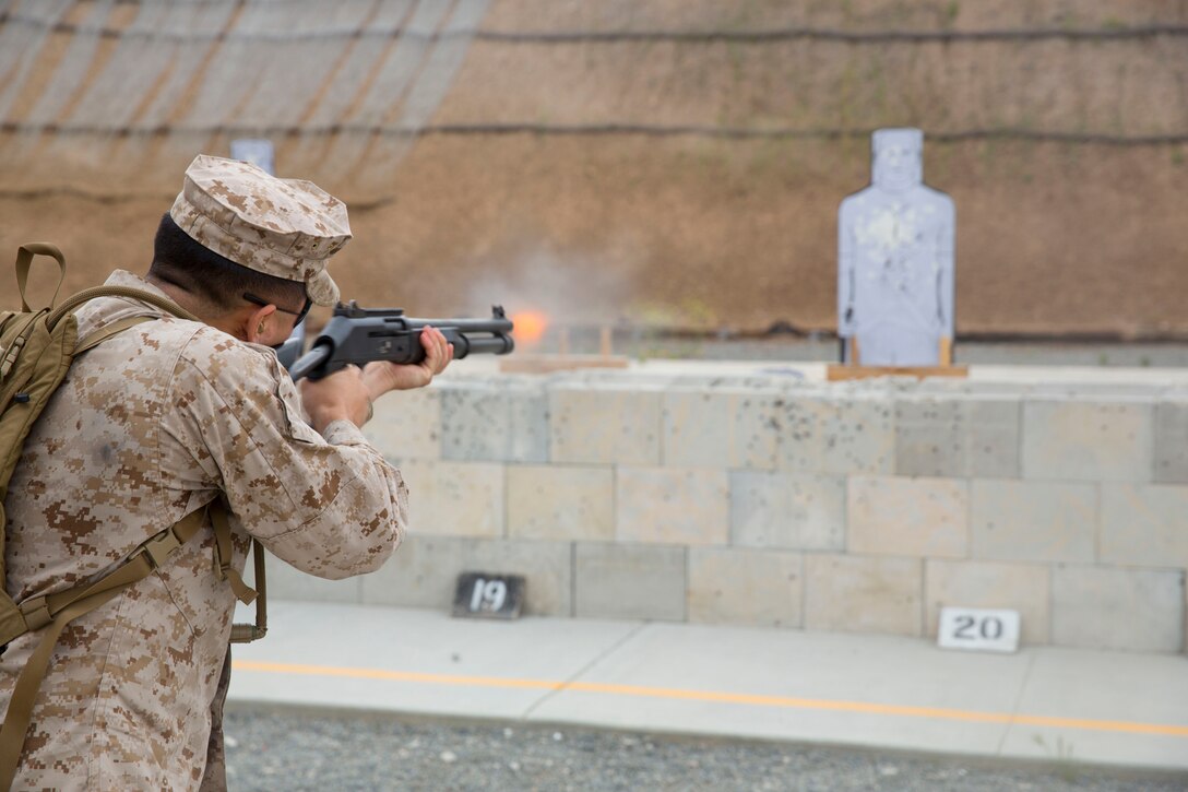 MARINE CORPS AIR STATION MIRAMAR, Calif. – Cpl. Jae Yi, an administrative specialist with Headquarters and Headquarters Squadron, fires an M4 shotgun after a two mile squadron hike to Carlos Hathcock Range aboard Marine Corps Air Station Miramar, Calif., April 18. The Marines hiked an additional three miles back after receiving professional military education classes.   