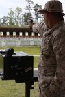 Sgt. Richard N. West, a drill instructor from Marine Corps Recruit Depot Parris Island, S.C., Eastern Division Team, fires the National Match M1911 .45 caliber service pistol one-handed, with his other hand placed in the pocket for stability, during the individual pistol portion of the 2014 Marine Corps Match Championships from April 14-16 aboard the Weapons Training Battalion ranges at Stone Bay. The individual pistol match is shot at the 25-yard line and 50-yard line, and must be shot one-handed, and the other hand can be placed in the pocket for stability. West is one of 84 competitors, and they competed in three different categories. The individual rifle match, the individual pistol match and the team rifle and pistol match. (U.S. Marine Corps photo by Sgt. Alicia R. Leaders/Released)
