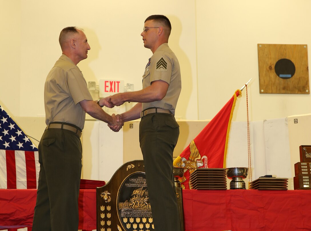 Sgt. Richard N. West, a drill instructor from Marine Corps Recruit Depot Parris Island, S.C., receives a medal from Col. James W. Clark, deputy commander of Marine Corps Base Camp Lejeune and guest speaker, during the 2014 Marine Corps Match Championships Award Ceremony aboard the Weapons Training Battalion gymnasium at Stone Bay, April 18. Eighty-four competitors competed in the championships in three different categories. The individual rifle match, the individual pistol match and the team rifle and pistol match. (U.S. Marine Corps photo by Sgt. Alicia R. Leaders)